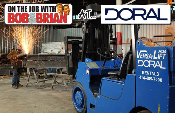 Men in a warehouse around machines with "On the job with Bob & Brian at Doral" overlay